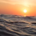 Captivating ocean waves with a vibrant sunset sky, perfect for tranquil moments.